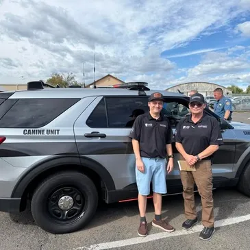 Southwest Emergency Products team members with Canine Unit vehicle